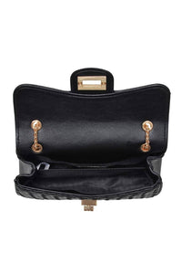 Black handbag with gold hardware on a white background