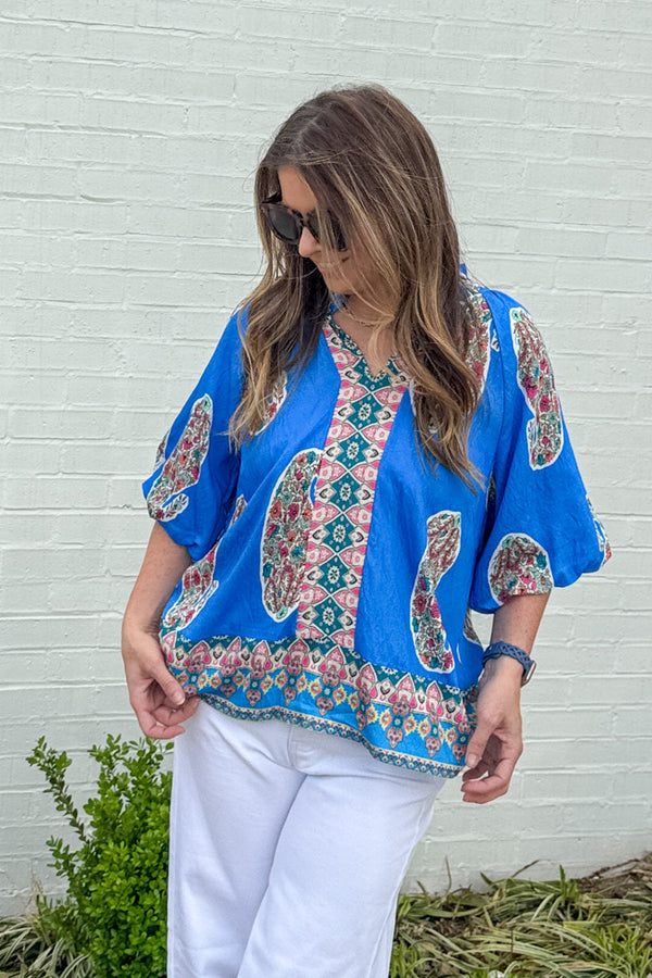 Woman wearing Paisley Print cerulean blue puff sleeve top by Umgee featuring vibrant paisley patter