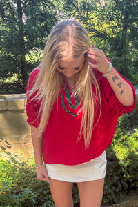 Entro Red Top with plaid trim untucked