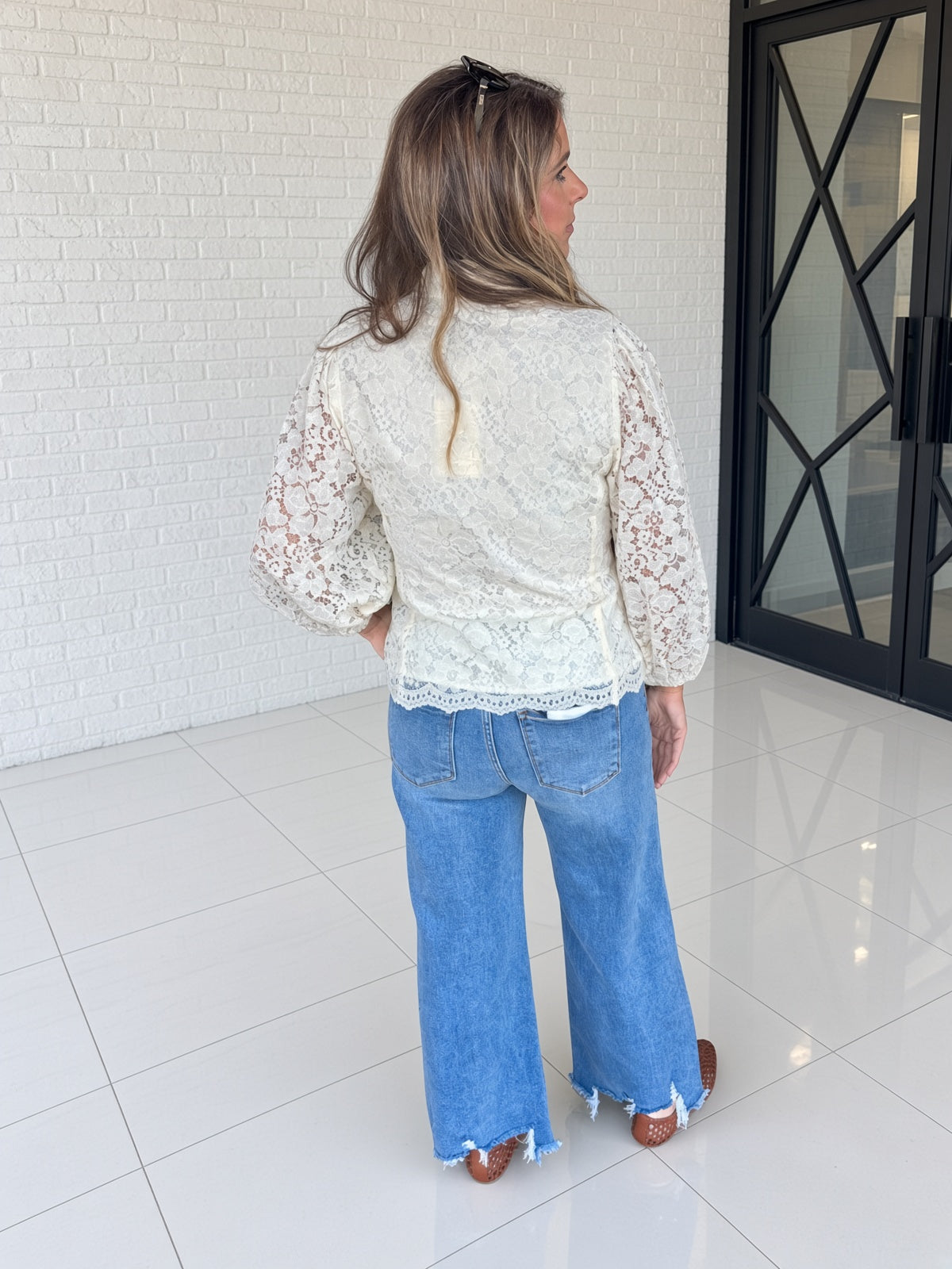 Back view of Entro off white lace top with puffed sleeves
