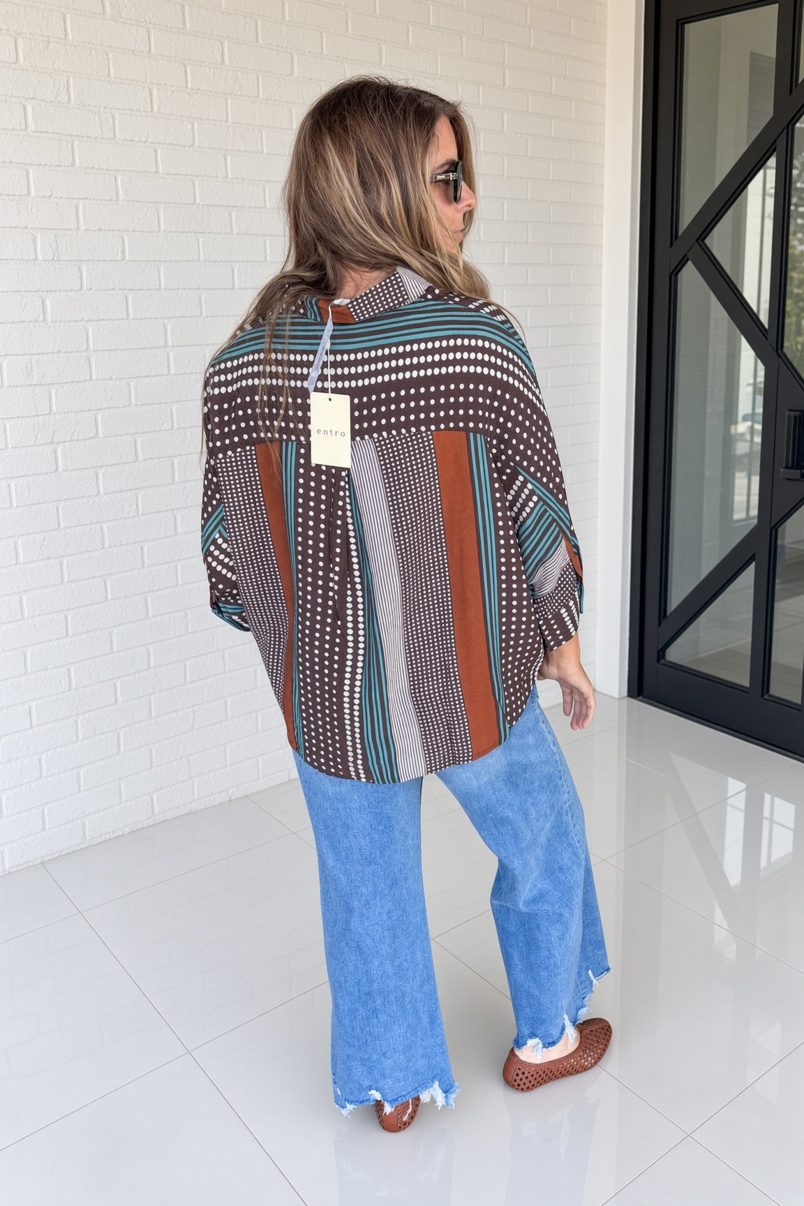 Back view of Entro brown and teal button front top