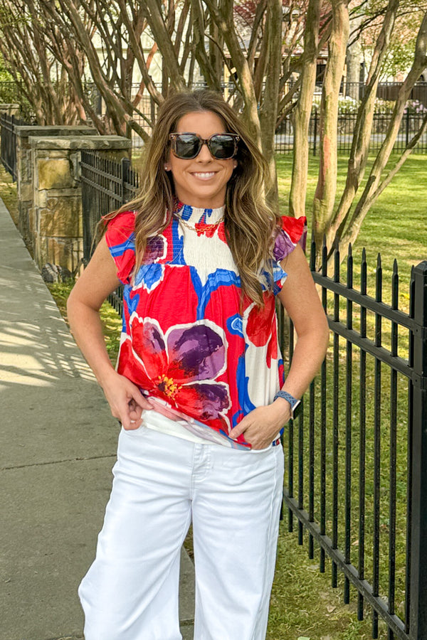 Woman wearing Time For It All smocked neck floral tank top in multi colors by TCEC with flutter sleeves