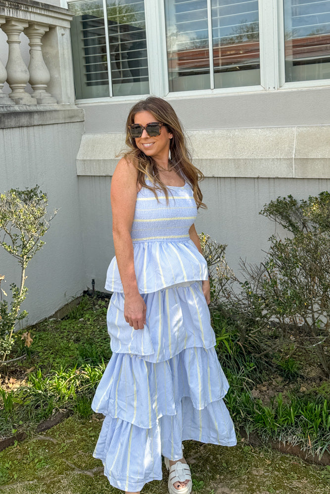 Woman wearing First Class Dreamin blue yellow striped tiered maxi dress by TCEC with smocked bodice