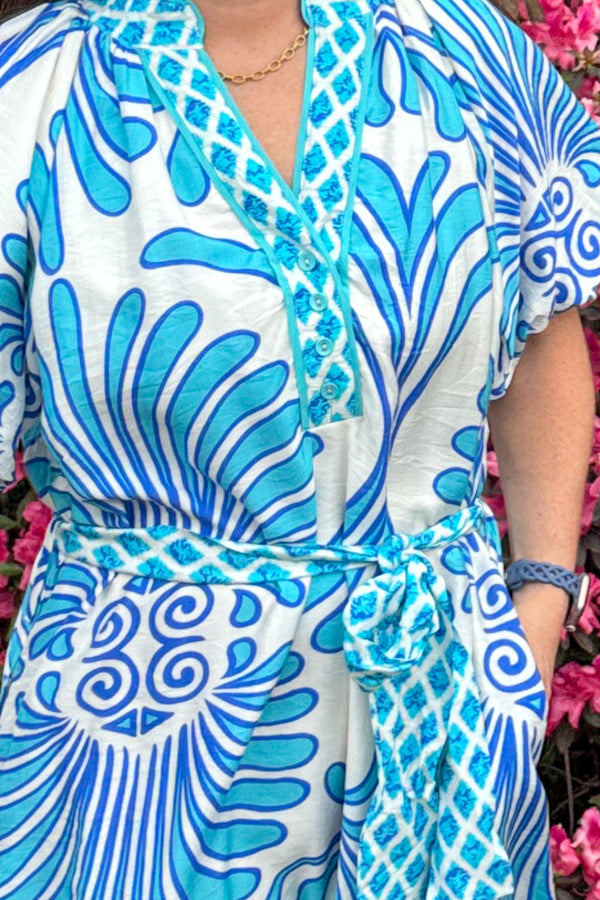 Woman wearing Seaside Walks Paraiba white blue midi dress by Umgee with belted waist tie
