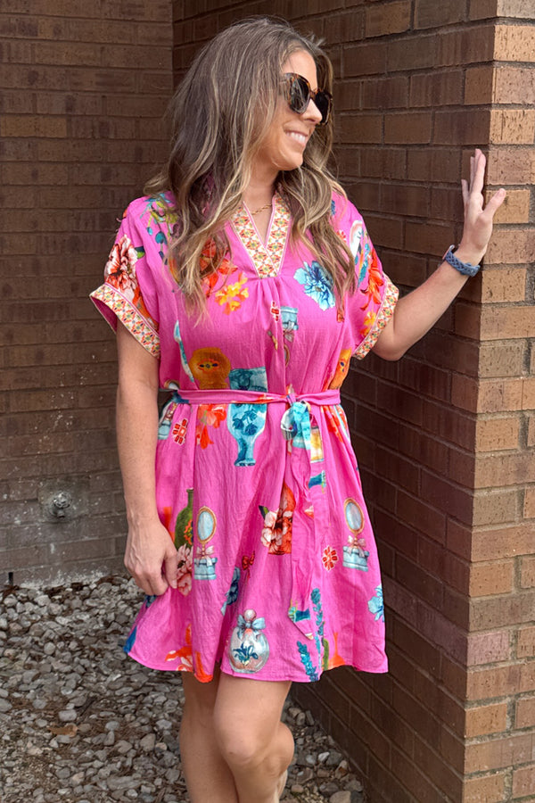 Woman wearing Spring Strolls peony pink floral belted dress by Umgee with flowy fit
