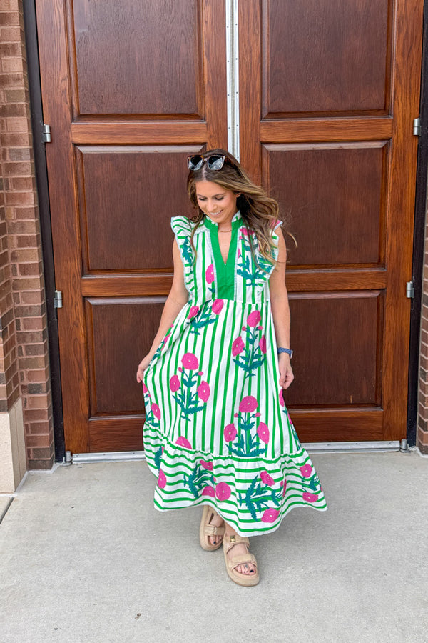 Woman wearing Pops Of Pink green white stripe pink floral midi dress by Umgee with flutter sleeves