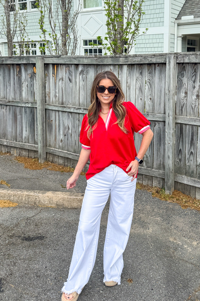 Woman wearing She's Sporty red contrast trim scuba top by Umgee with pink and white accents