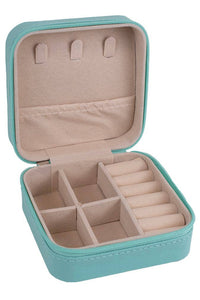 Turquoise jewelry box with beige interior on a white background